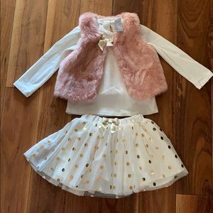 Pink fur vest with long sleeve and polka dot skirt